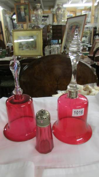 Two cranberry glass bells (no clangers) and a sugar sifter. Collect only.