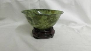 A small jade bowl on stand, 12.5 cm diameter.