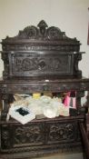 A heavily carved oak antique cabinet/buffet.