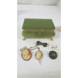 Two silver brooches, a cameo pendant and a cameo brooch in an onyx jewellery box.