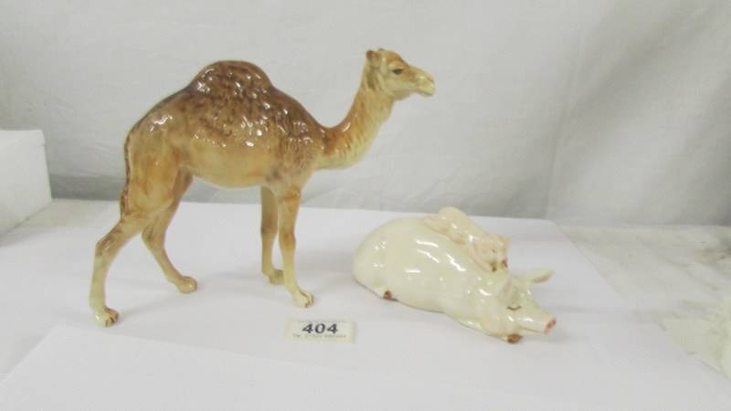 A Beswick camel and a Beswick pig, (pig has chip to ear).