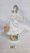 A Royal Worcester Old Country Ways series figurine 'The Milkmaid'. 1016/9500.