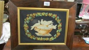 A mahogany framed tapestry depicting doves. Collect only.