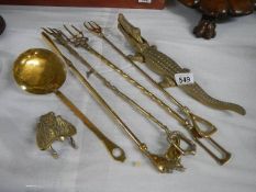 A mixed lot of brass ware including toasting forks, shoe horn, crocodile nut cracker etc.,