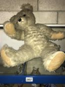 A large vintage Teddy Bear. Distressed and moulting.