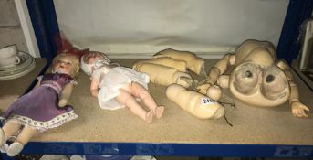 A pair of vintage dolls and doll body parts