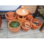 A selection of terracotta plant pots and a capped decorative chimney. Collect only.