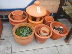 A selection of terracotta plant pots and a capped decorative chimney. Collect only.