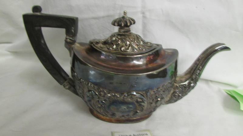 A decorative silver teapot. Approximately 330 grams.