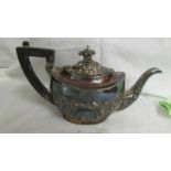 A decorative silver teapot. Approximately 330 grams.