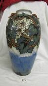 A spectacular 15.5" vase by Doulton. The lower part is a blue/green colour and above are stylized