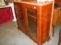 An ormolu mounted two door cabinet with marble top.