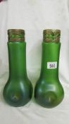 A pair of green art glass vases with metal rims. 30 cm tall.