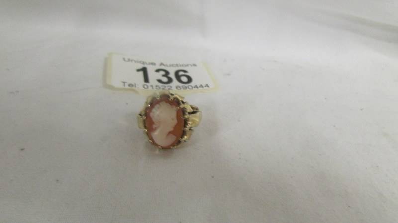 A cameo ring set female profile in textured and fancy 9ct gold mount, size J half.