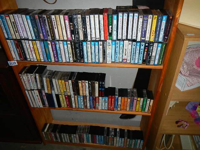 Three shelves of cassette tapes, mostly easy listening and classical.