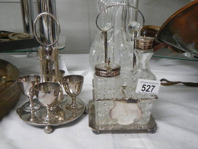 A silver plate four bottle cruet and a silver plate egg cup stand.