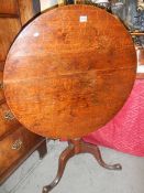 An early Victorian oak tripod table.