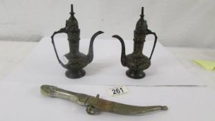 Two small eastern metal coffee pots and a dagger in sheath.