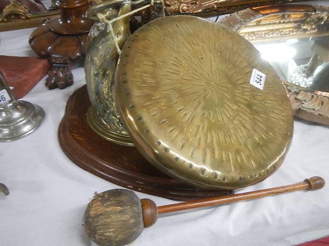 A brass dinner gong. Overall in good condition for age.String holding gong in place.A replacement