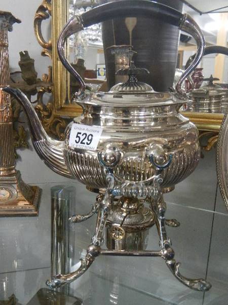 A silver plate spirit kettle on stand.