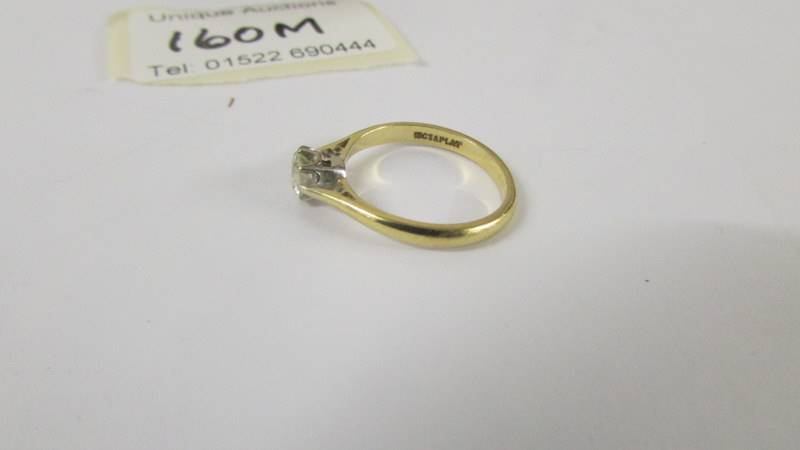 A solitaire diamond ring mounted in 18ct gold and platinum. size L. - Image 3 of 3