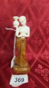 An antique carved ivory and wood female figure. Available for UK shipping only.