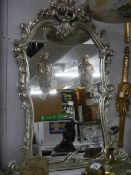 An ornate Regency style silvered carved mirror, 104 x 86 cm. Collect only.