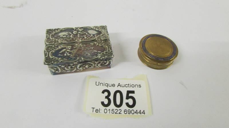 A silver circa 1977 pill box and a miniature engine turned powder compact.