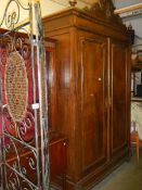 A large two door French armoire with paneled doors. (Width 148cm , depth 52cm, height 240cm.)