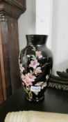 A Victorian black glass hand painted vase.