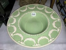 A large wedgwood Eturia green glazed Jasper ware charger bowl (chip under foot)