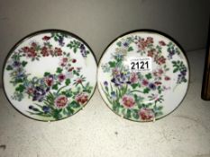 A pair of oriental hand painted porcelain plates
