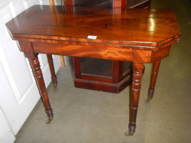 A Victorian mahogany fold over card table.