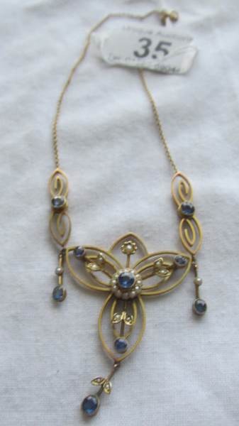 A 9ct gold necklace set sapphire and seed pearls.
