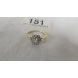 A diamond old cut cluster ring stamped 18ct gold. Size L.