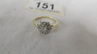 A diamond old cut cluster ring stamped 18ct gold. Size L.