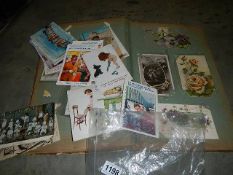 A postcard album of early 20th-century greeting cards, mainly flowers and a quantity of loose