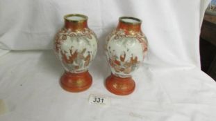 A pair of 19th century Japanese Kutani vases with brass trims, 16.25 cm tall.