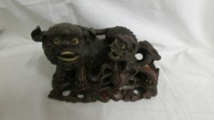 An early Chinese carved wood Dogs of Foo group.