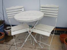 Two cream coloured metal and wood folding chairs and a table. Collect only.