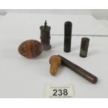 Five pieces of treen comprising four needle holders (one in the shape of an castle), one pen nib and