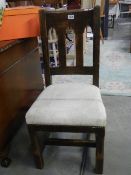 A Liberty &Co Oak chair. Gothic style early 20th Century. Original label. Collect only.