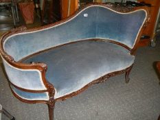 A mahogany framed Victorian sofa in blue.