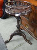 A mahogany wine table with gallery and carved legs.