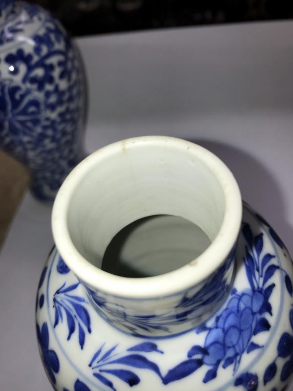 A pair of early Chinese blue and white lidded vases (both lids a/f) and a blue and white flask. - Image 14 of 25