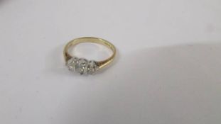 A three stone yellow gold diamond cluster ring. size M half.