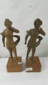 A pair of 18th century carved boxwood putti baroque figures mounted on teak bases, missing wings