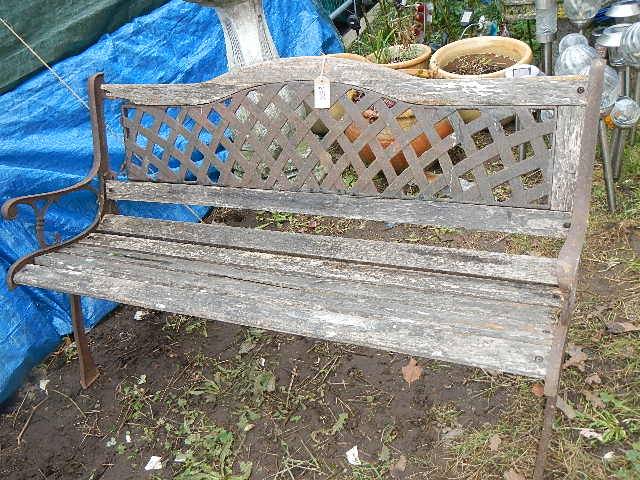 A cast metal and wood garden bench. 128 x 74 x 55 cm. Collect only.