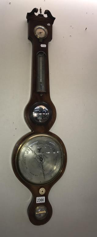 A victorian wheel barometer with silver dial and swan pediment