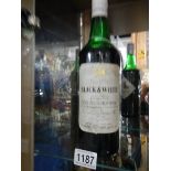 A bottle of Black & White Buchanan's Scotch whisky.